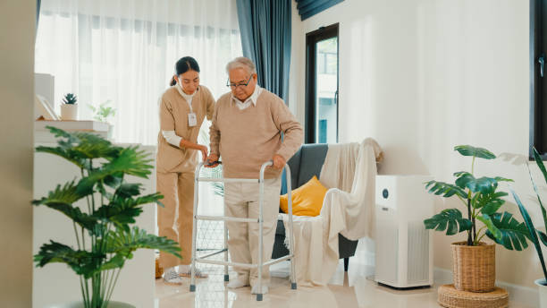 Healthcare Assistant assisting older resident with mobility
